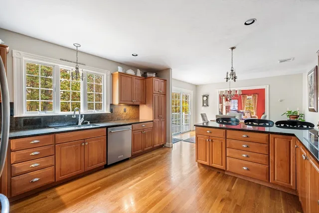 a kitchen with granite countertop wooden cabinets and a sink