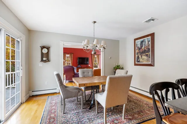 a dining room with furniture a rug and a chandelier