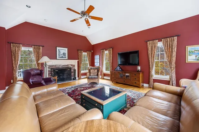 a living room with furniture flat screen tv and a fireplace
