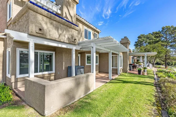a view of a house with a backyard porch and sitting area