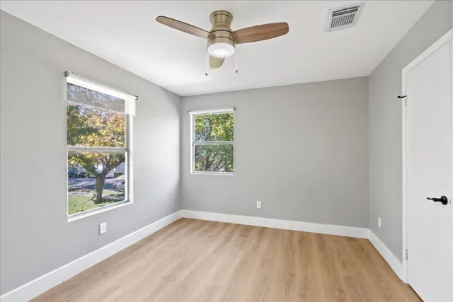 wooden floor in an empty room with a window