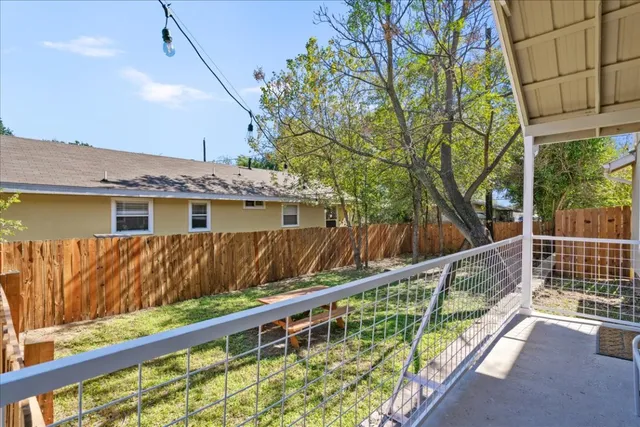 a view of a house with a wooden deck