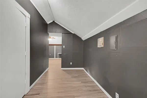 a view of a hallway with wooden floor