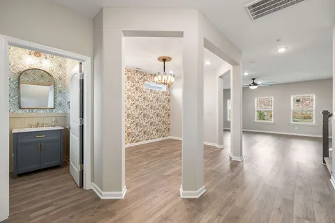 a view of a hallway and wooden floor a kitchen with wooden floor