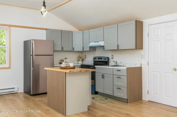 a kitchen with appliances cabinets and a sink