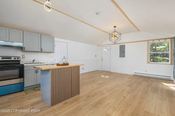 a view of kitchen with a sink cabinets and wooden floor