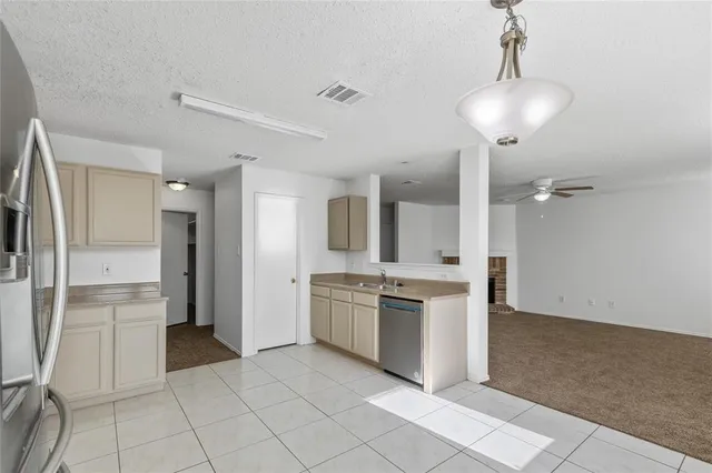 a large kitchen with cabinets and stainless steel appliances