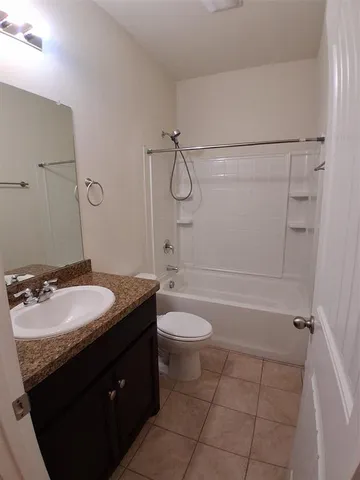 a bathroom with a granite countertop sink toilet mirror and shower