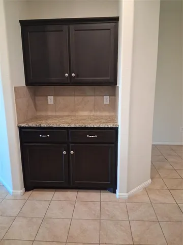 a kitchen with granite countertop white cabinets and granite counter tops
