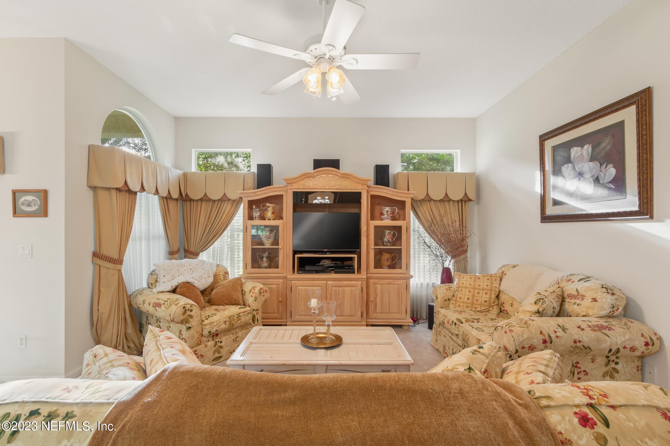 1796 Keswick Road St. Augustine, FL 32084 - Photo 5 of 48 a bedroom with bed and a chandelier