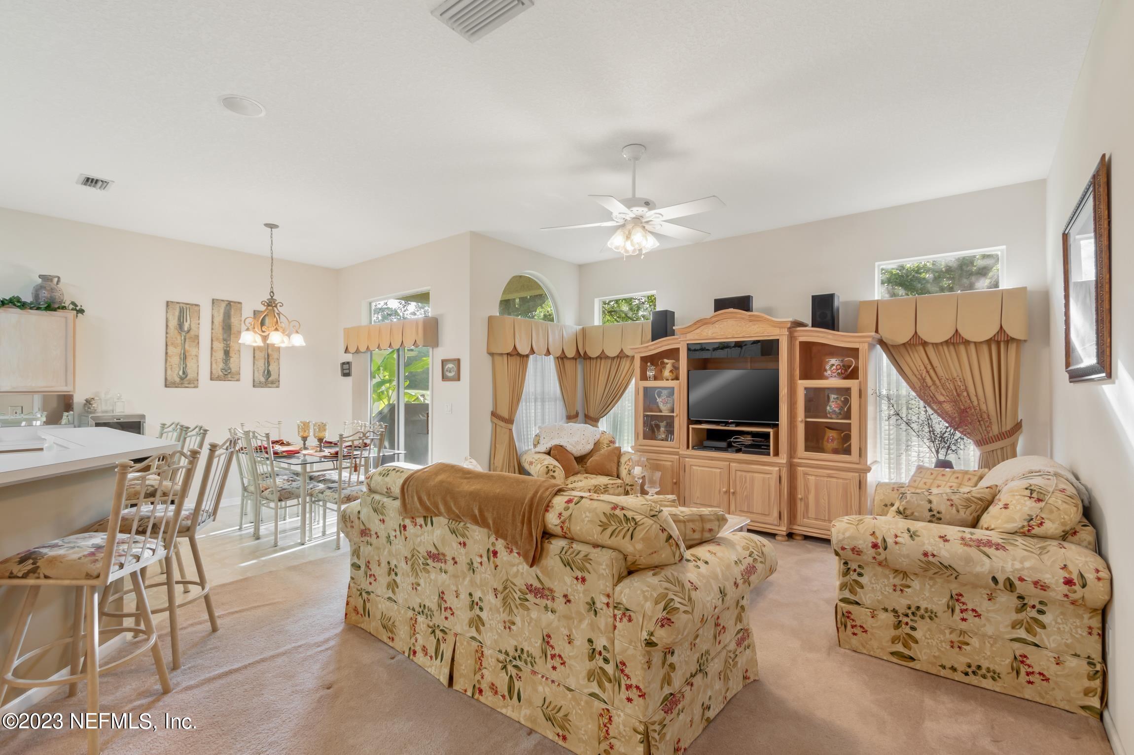 1796 Keswick Road St. Augustine, FL 32084 - Photo 6 of 48 a living room with furniture and a flat screen tv