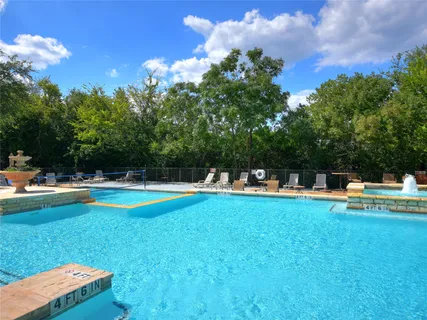 a swimming pool with outdoor seating and yard