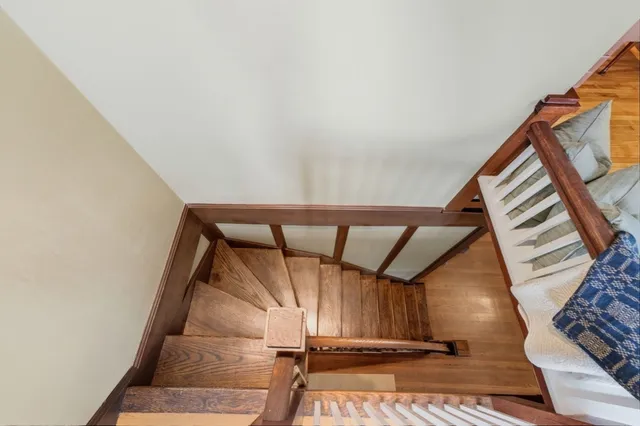 a view of staircase with white walls and a window