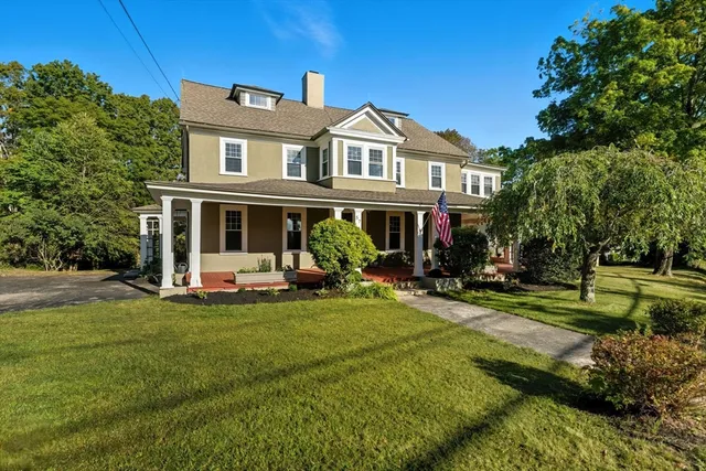 a view of a house with a yard porch and sitting area