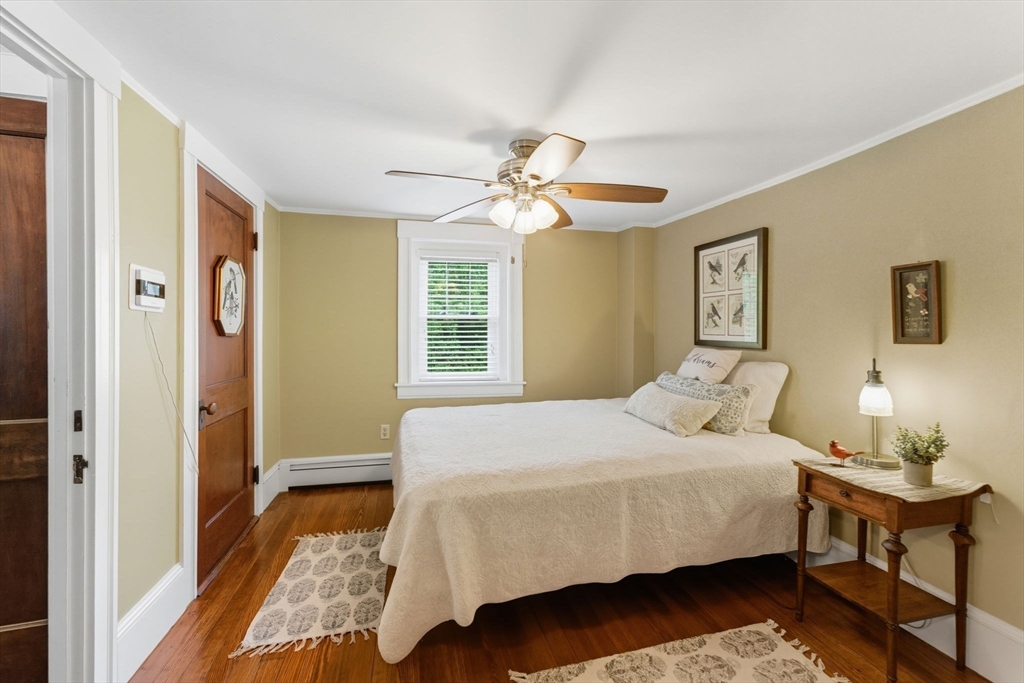 57 Upper Gore Road Webster, MA 01570 - Photo 24 of 42 a bedroom with a bed and a chandelier