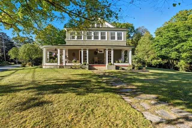 a view of a porch with chairs and backyard