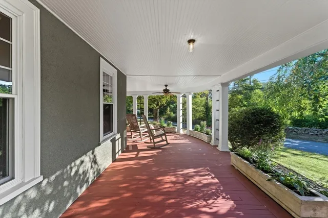 a view of a porch with furniture and wooden floor