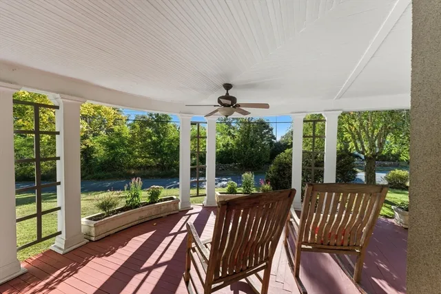 a view of a patio with a table chairs and a floor to ceiling window