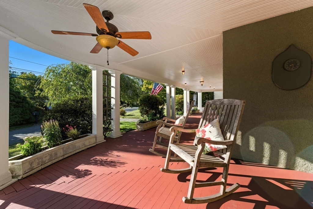 57 Upper Gore Road Webster, MA 01570 - Photo 38 of 42 a view of a patio with a table chairs and a floor to ceiling window