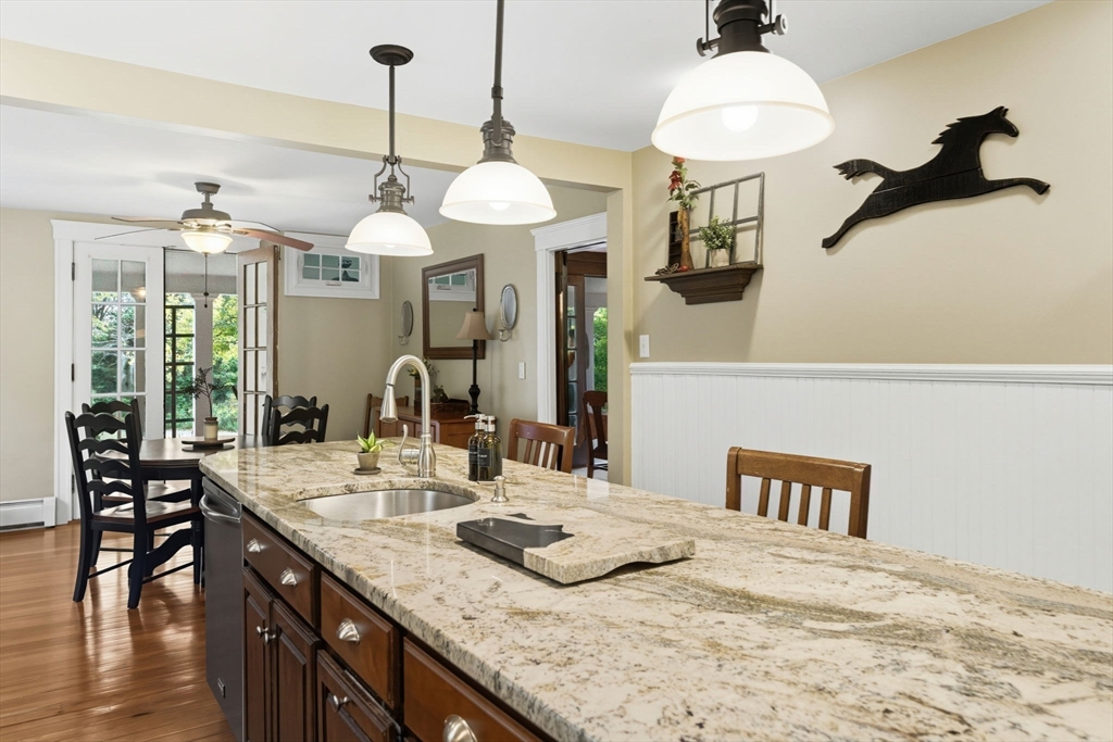 57 Upper Gore Road Webster, MA 01570 - Photo 10 of 42 a kitchen with kitchen island granite countertop a table and chairs in it