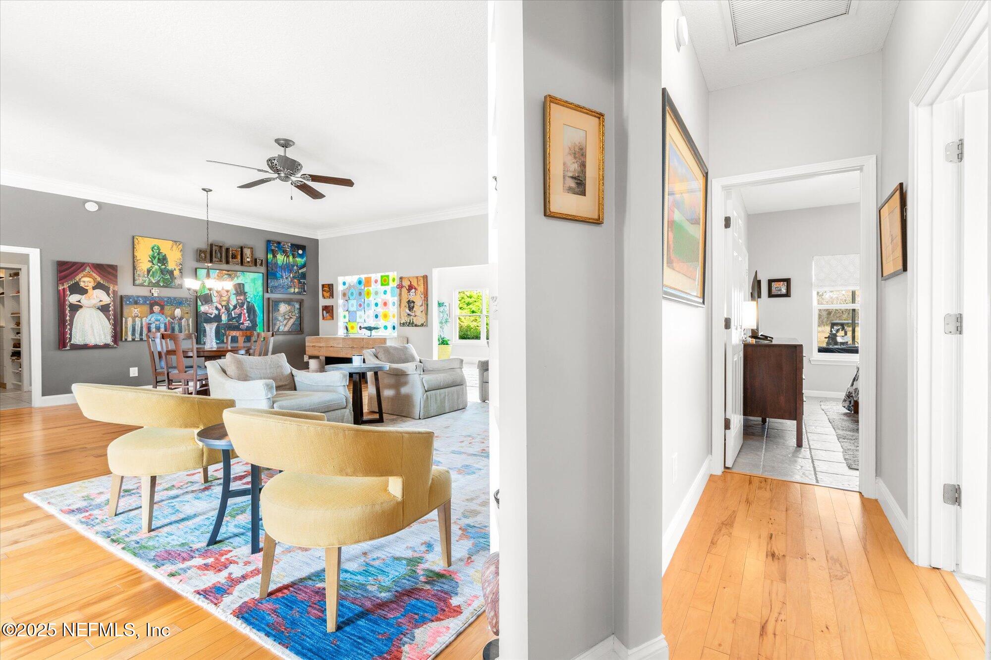 606 Teeside Court St. Augustine, FL 32080 - Photo 20 of 47 a living room with dining table and a painting on the wall