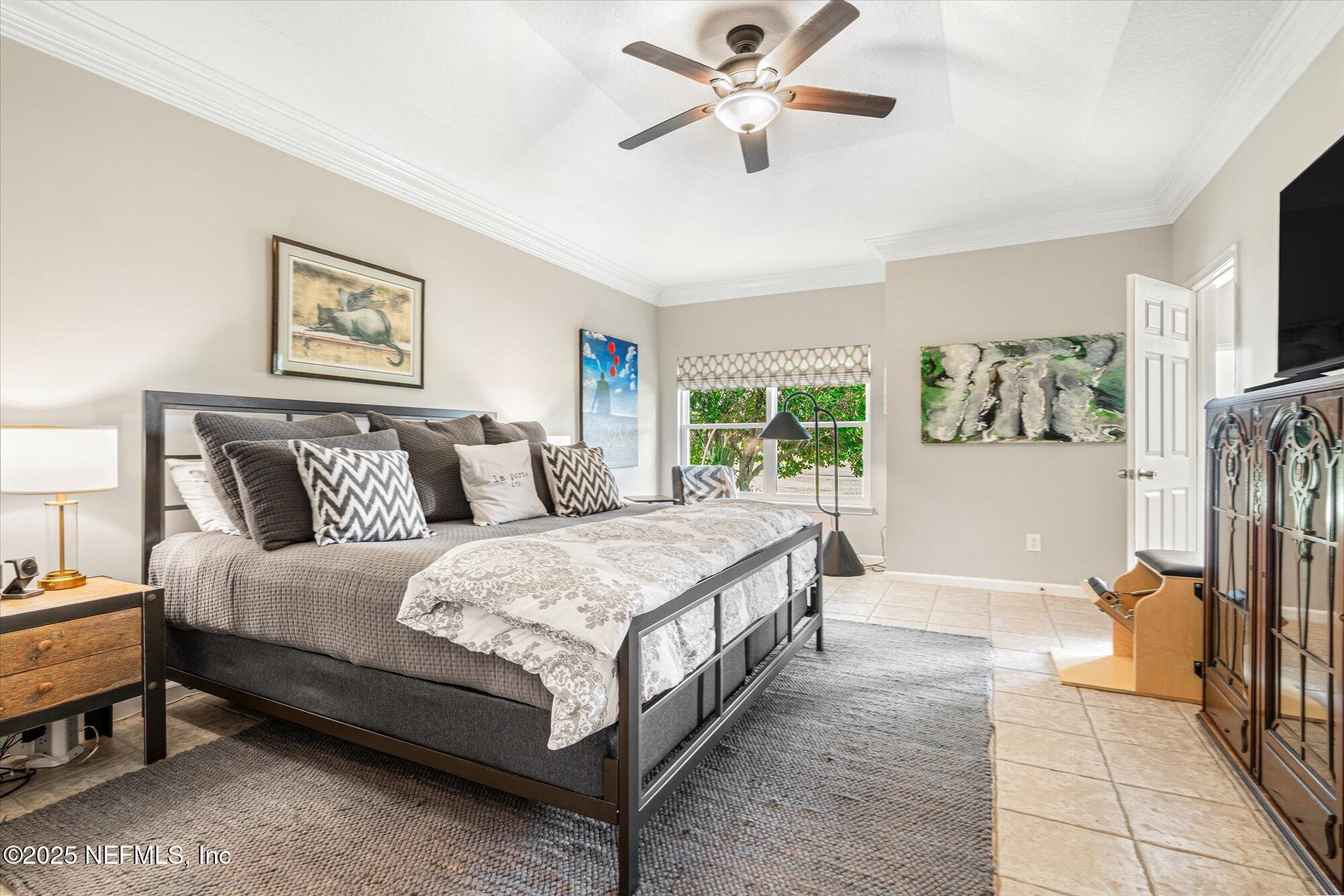 606 Teeside Court St. Augustine, FL 32080 - Photo 22 of 47 a spacious bedroom with a bed and a chandelier
