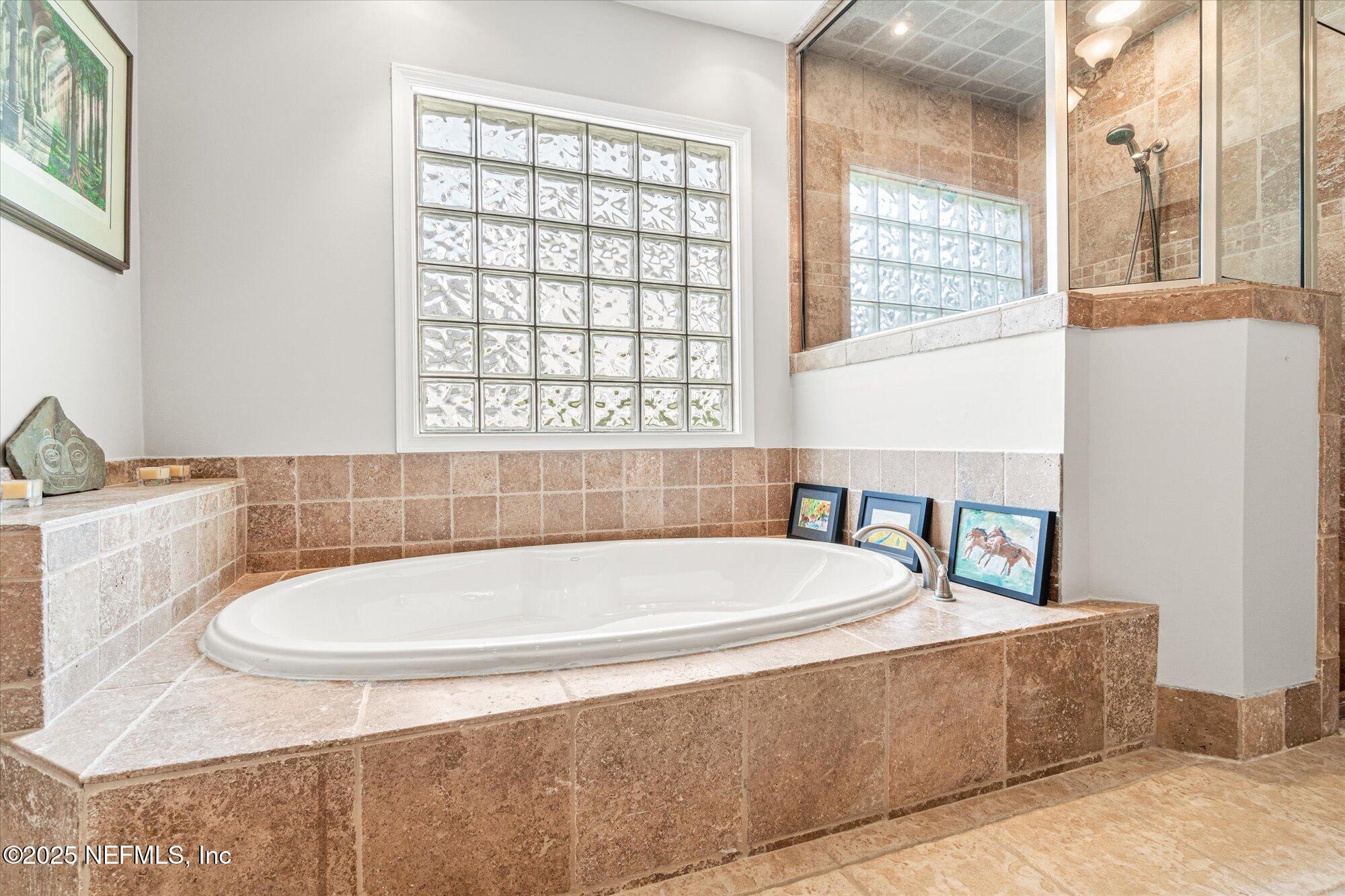 606 Teeside Court St. Augustine, FL 32080 - Photo 27 of 47 a bath tub sitting in a bathroom next to a window