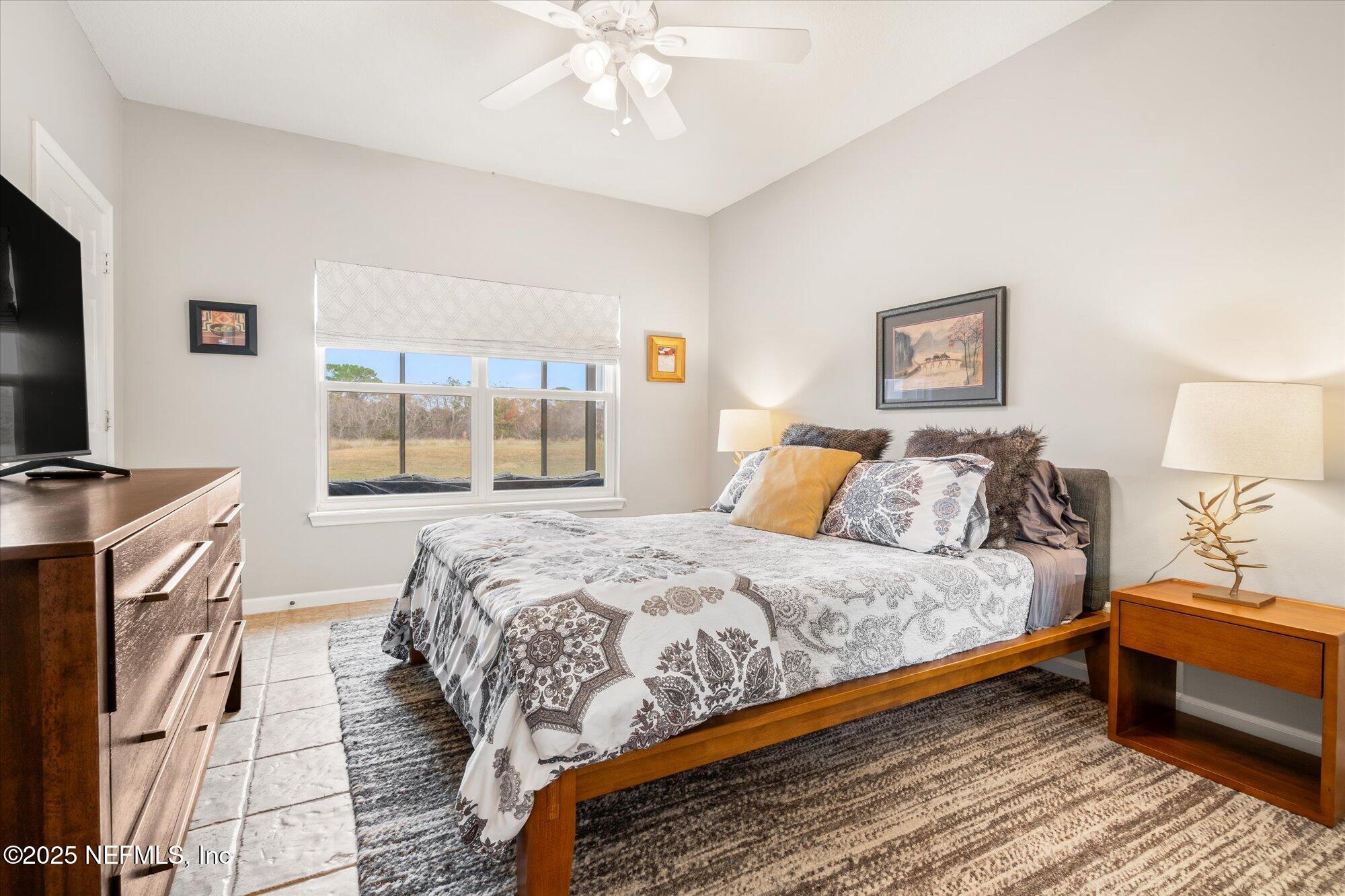 606 Teeside Court St. Augustine, FL 32080 - Photo 31 of 47 a bedroom with a bed and a window