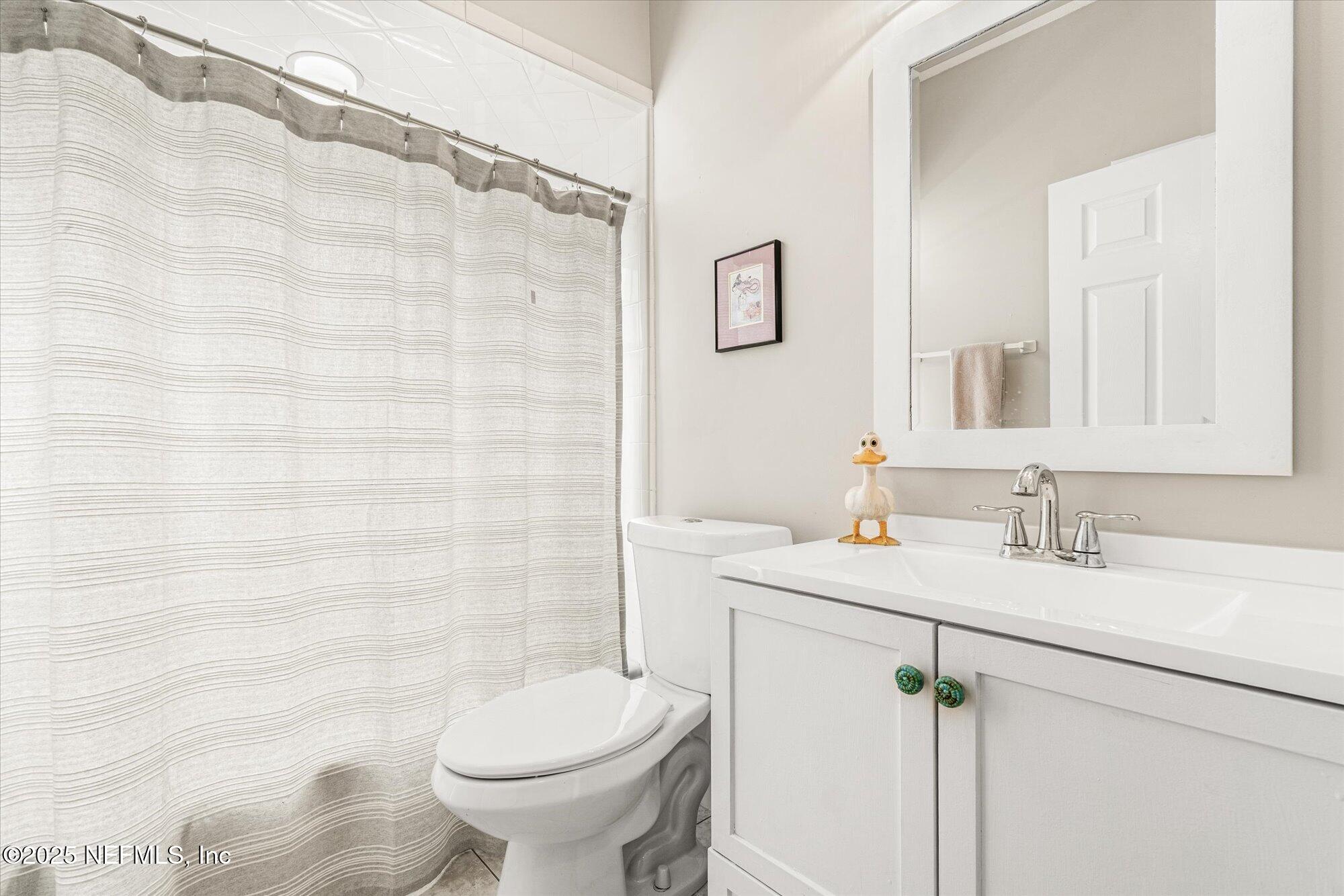 606 Teeside Court St. Augustine, FL 32080 - Photo 32 of 47 a bathroom with a sink a toilet and a mirror
