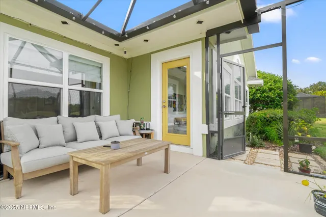 a balcony with furniture and a potted plant