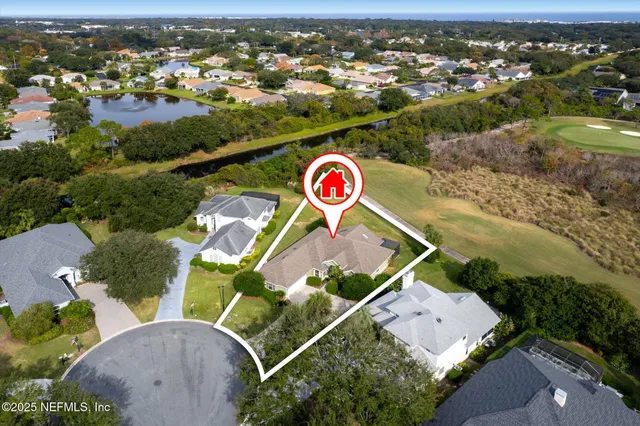 an aerial view of residential house with outdoor space and parking