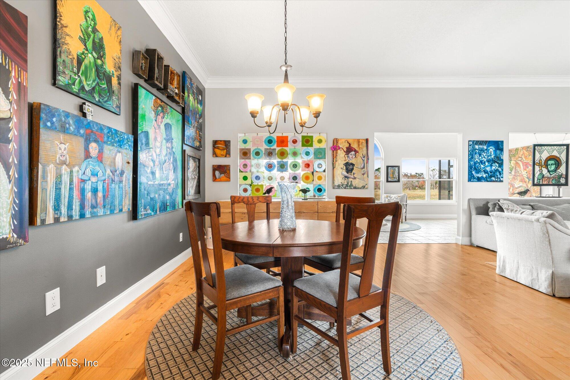 606 Teeside Court St. Augustine, FL 32080 - Photo 9 of 47 a dining room with furniture a chandelier and wooden floor