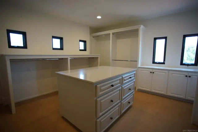 a kitchen with stainless steel appliances cabinets and wooden floor