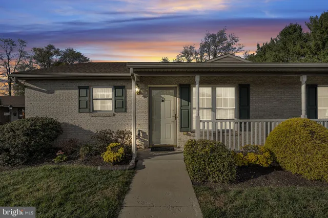 a view of a house with a small yard and a garden