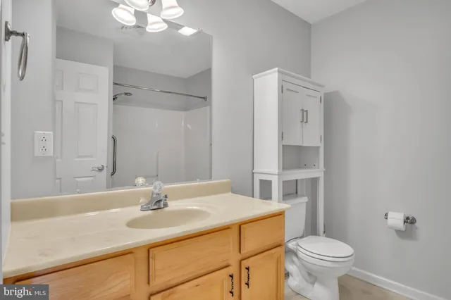 a bathroom with a sink toilet and a mirror