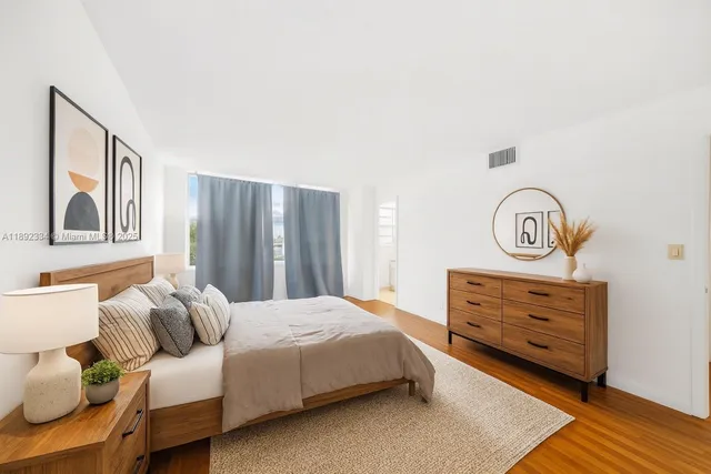 a bedroom with a bed and a dresser