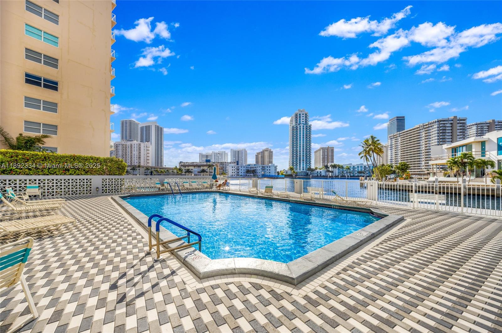 137 Golden Isles Drive, Unit 508 Hallandale Beach, FL 33009 - Photo 18 of 24 a view of a swimming pool with a terrace