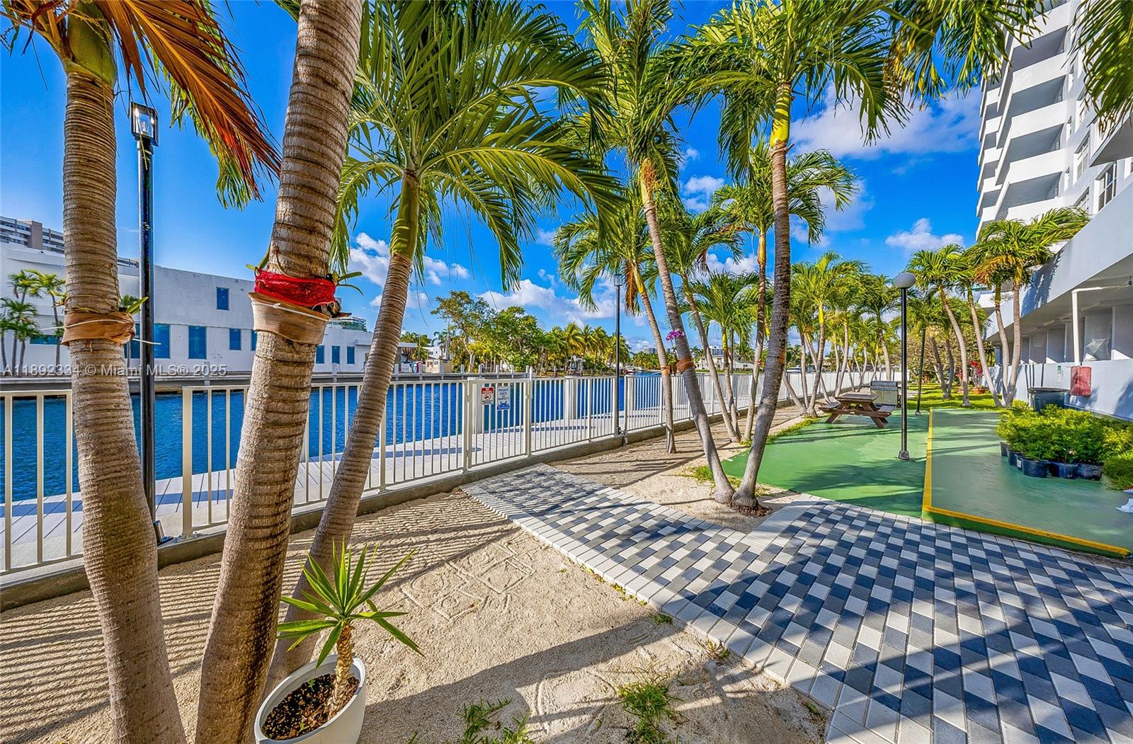 137 Golden Isles Drive, Unit 508 Hallandale Beach, FL 33009 - Photo 20 of 24 a view of a yard and a house in the background
