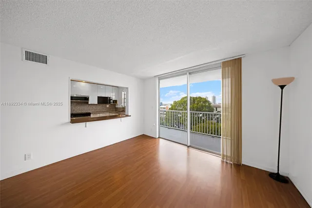 a view of a room with wooden floor and a window
