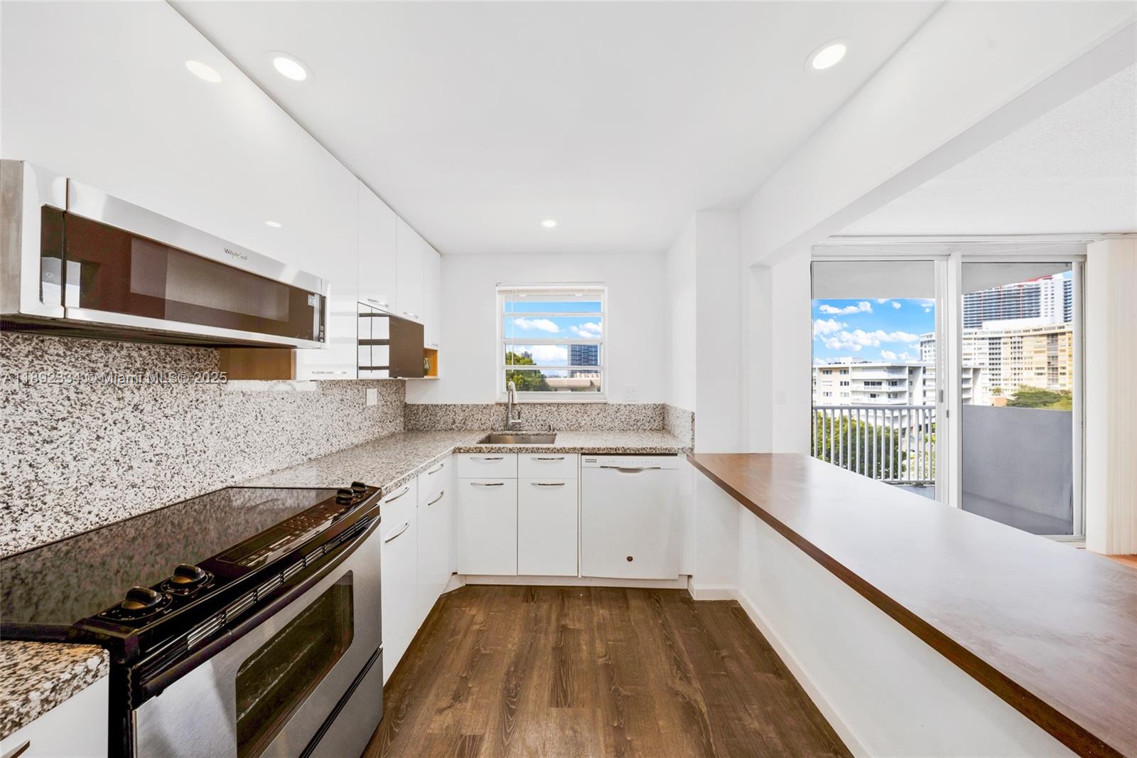 137 Golden Isles Drive, Unit 508 Hallandale Beach, FL 33009 - Photo 7 of 24 a large kitchen with a stove and a sink