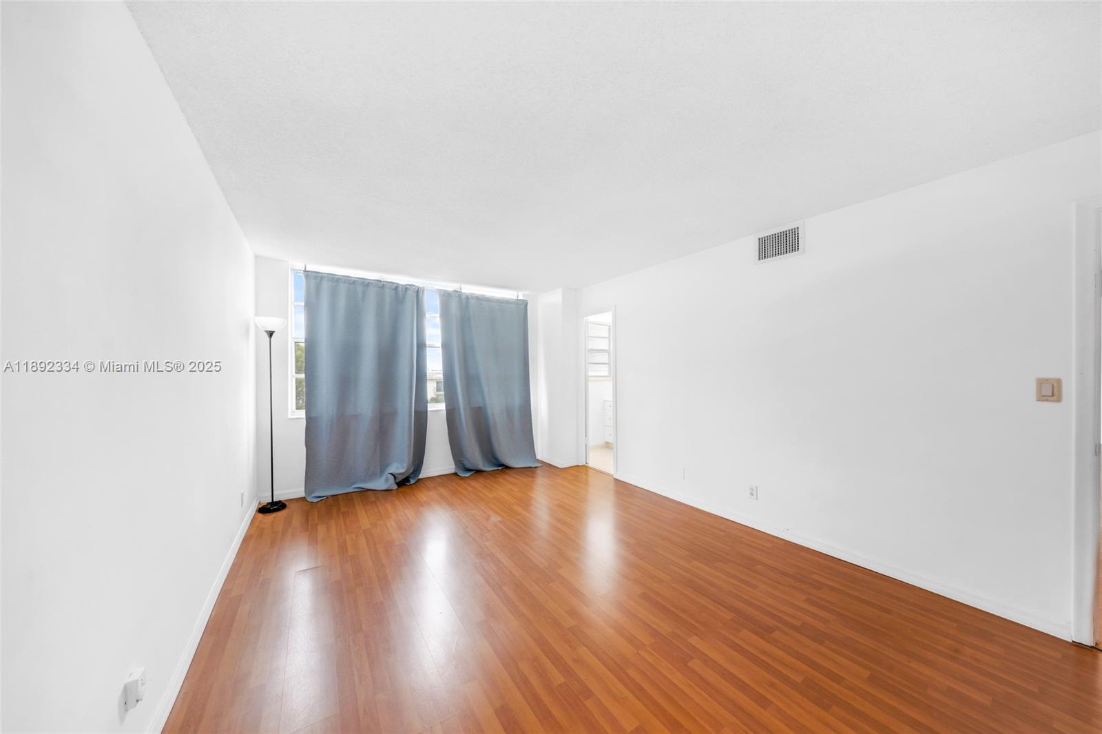 137 Golden Isles Drive, Unit 508 Hallandale Beach, FL 33009 - Photo 10 of 24 a view of an empty room with wooden floor