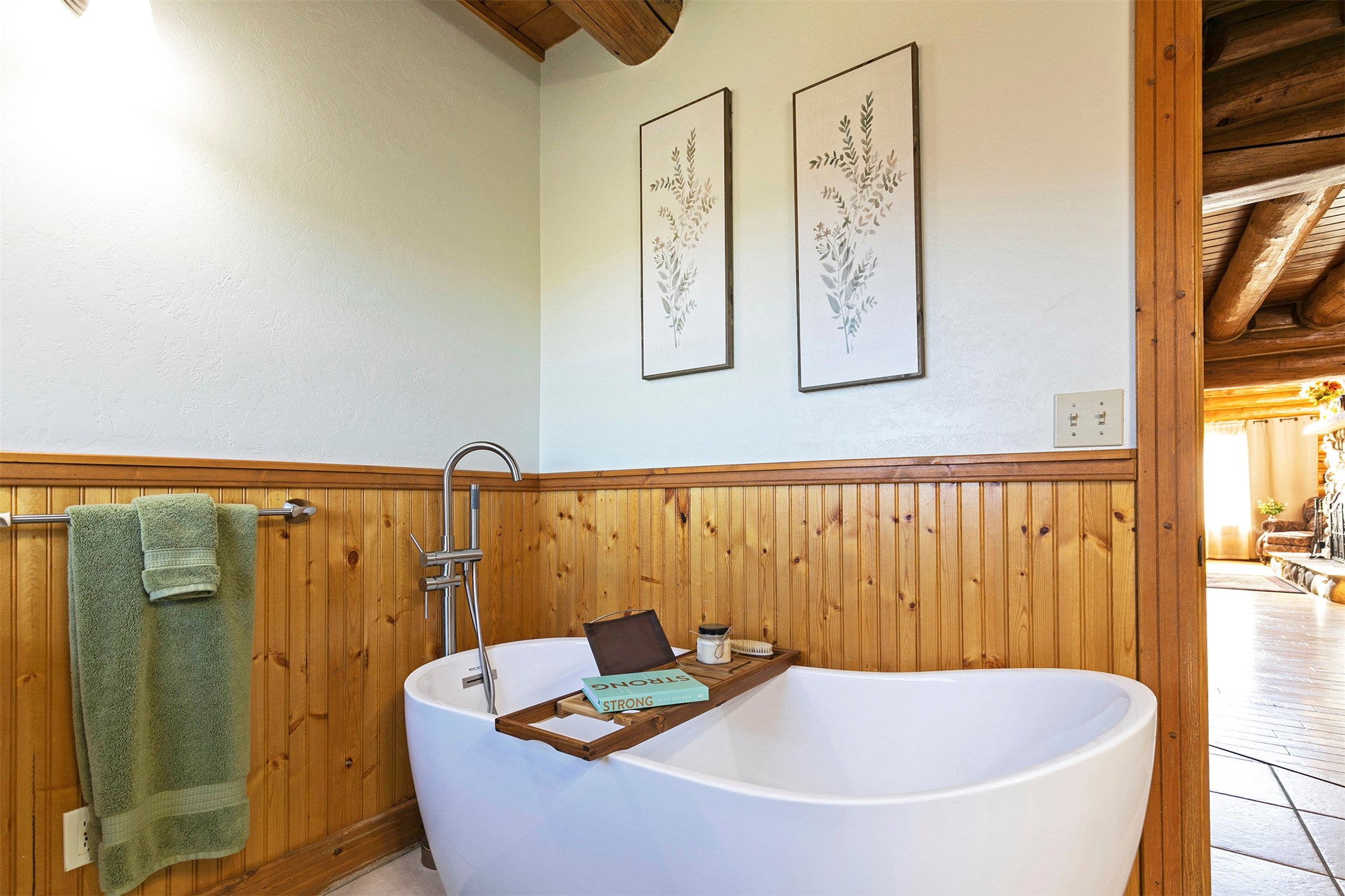 203 Hart Bench Road Darby, MT 59829 - Photo 16 of 56 The main floor bathroom features a generously sized soaking tub, offering the perfect retreat for relaxation and quiet moments.