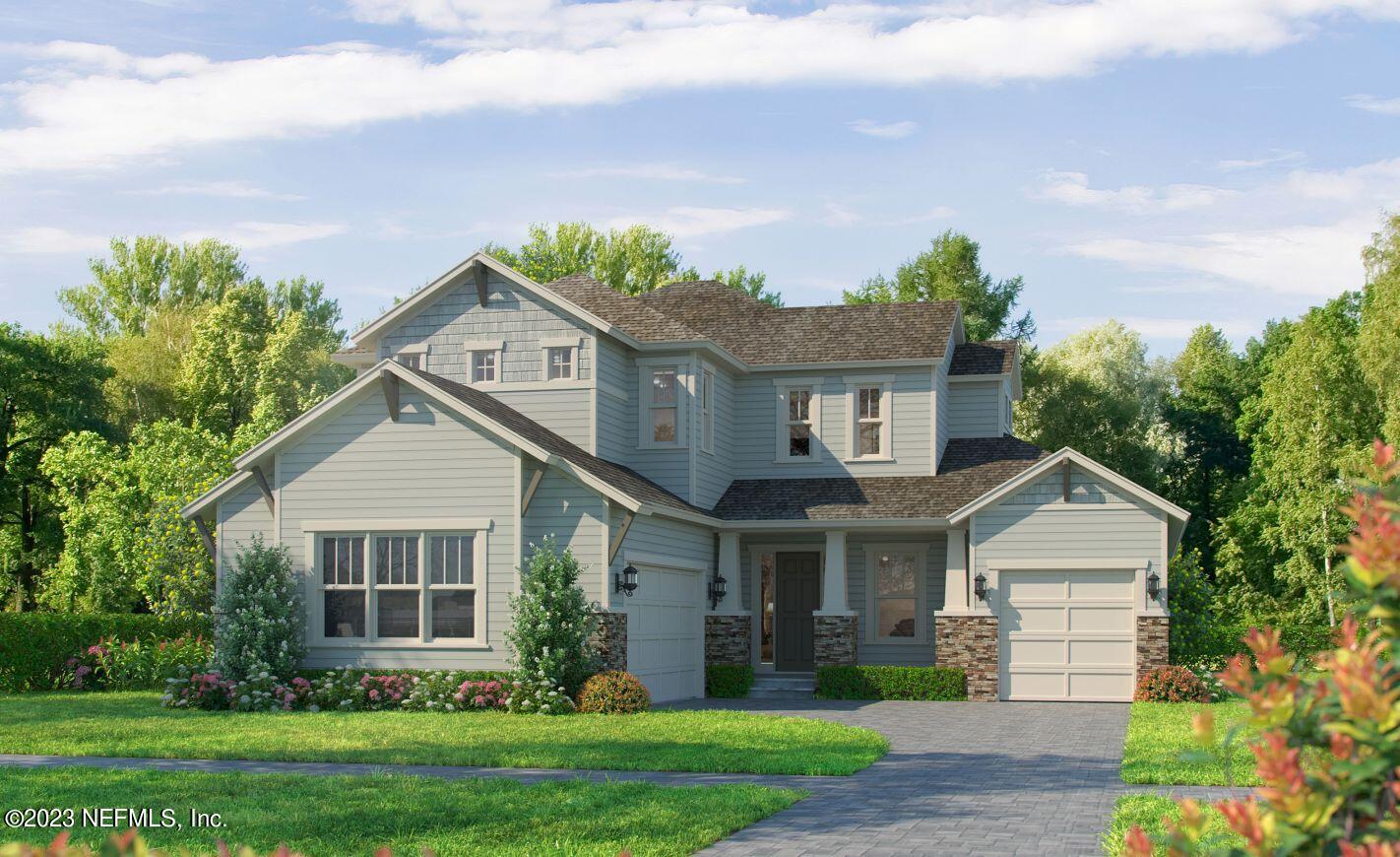 a front view of a house with a garden and plants