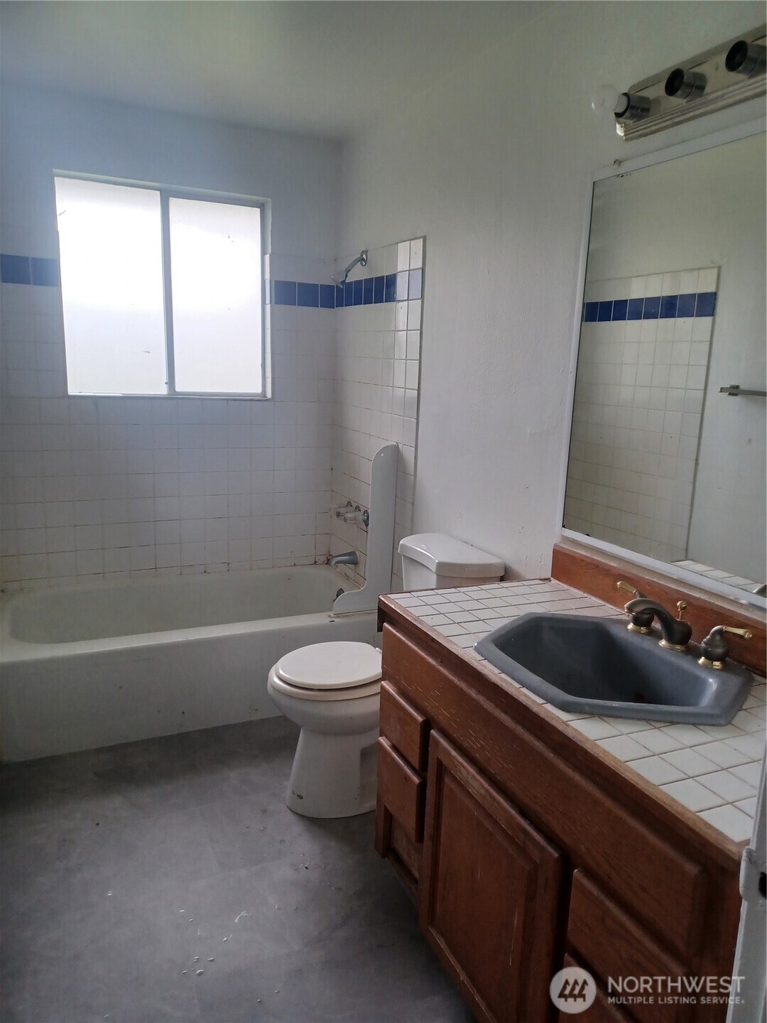 714 Union Avenue Steilacoom, WA 98388 - Photo 6 of 16 a bathroom with a granite countertop toilet sink and mirror