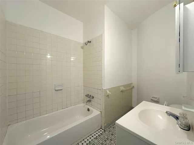 a bathroom with a sink a toilet and bathtub