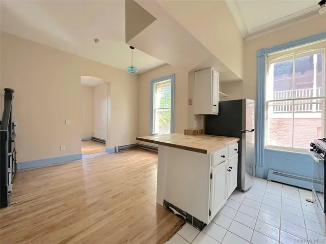 a kitchen with granite countertop a stove a sink and a refrigerator