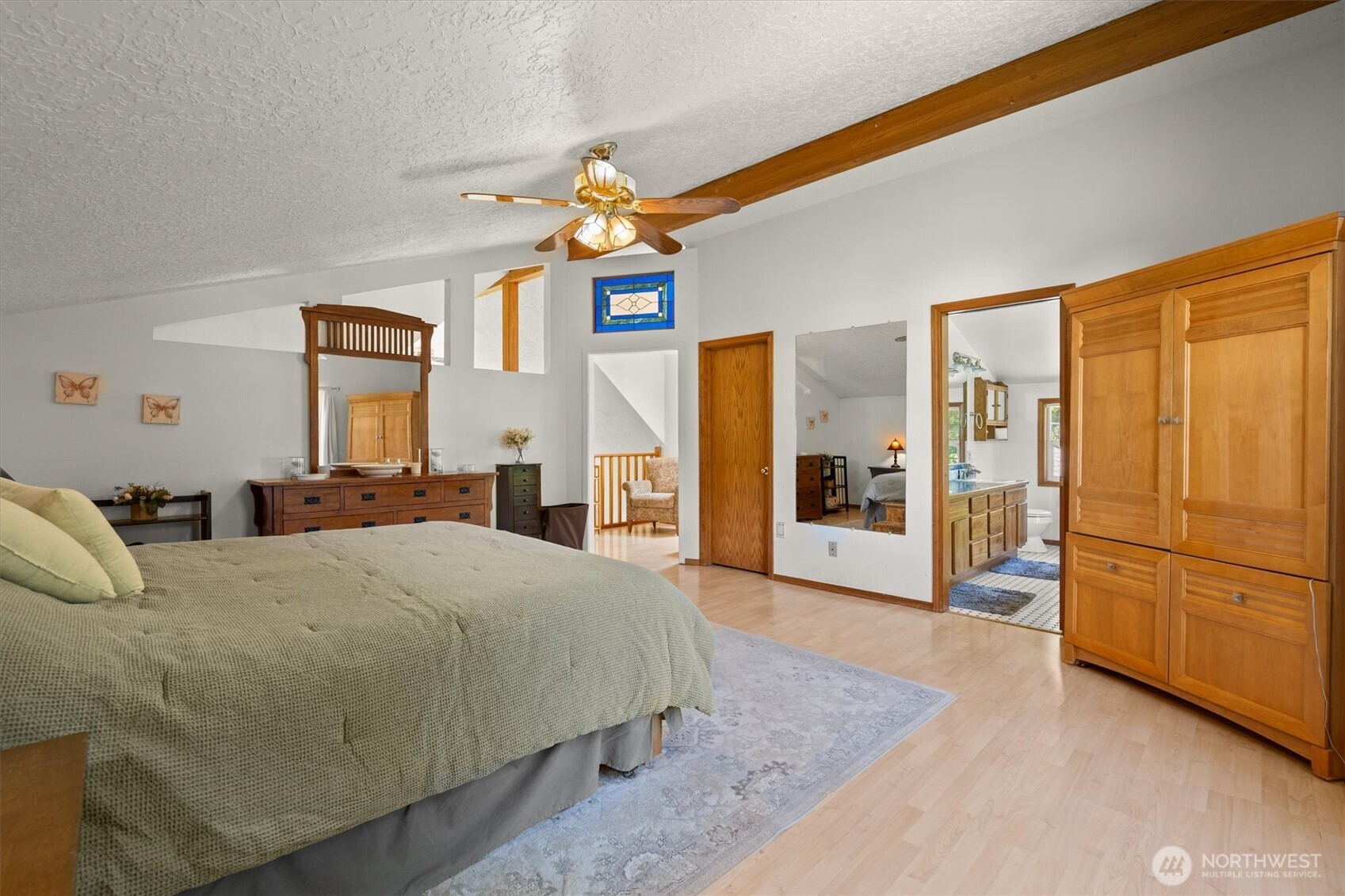 672 Walker Road Kelso, WA 98626 - Photo 15 of 40 a bedroom with a large bed a chandelier and dresser