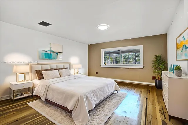 a spacious bedroom with a bed and a desk