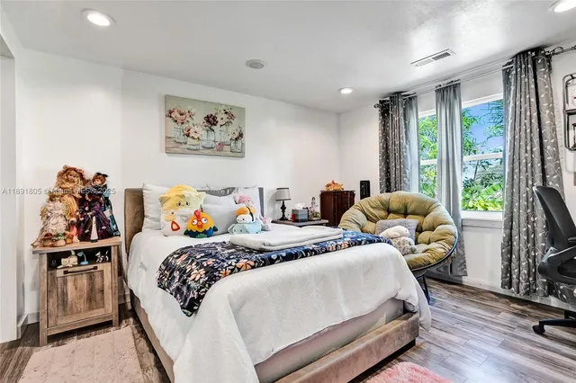 a bedroom with bed and a large window