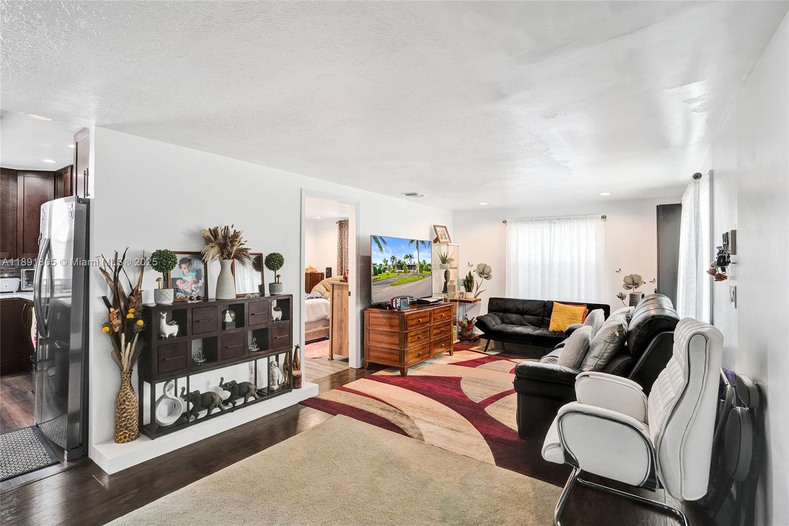 11201 Southwest 55th Street Miramar, FL 33025 - Photo 15 of 38 a living room with furniture a lamp and a fireplace
